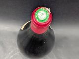 a bottle of wine that is sitting in a sink