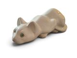 a small figurine of a cat on a white surface