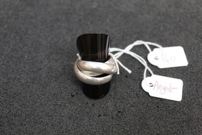 a silver ring with a black top and a price tag