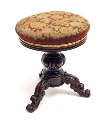 a small wooden stool with a cushion on top of it