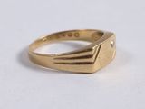 a close up of a gold ring with a diamond on it