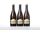 three bottles of wine sitting next to each other on a table