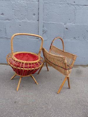 two wicker chairs and a basket on the sidewalk