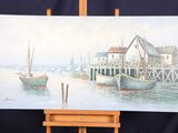 a picture of a painting on a easel with a boat in the water
