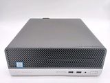 the back of a small computer with a keyboard on top of it