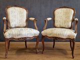 pair of french louis xv style armchairs with upholstered arms