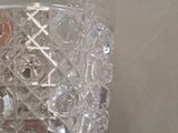 a glass vase with a lot of buttons inside of it