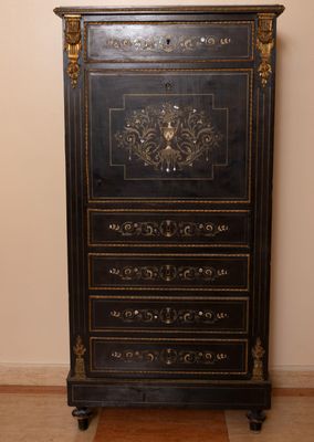 a black and gold chest of drawers in the corner of a room