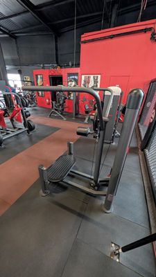 a gym room with a row of machines in it