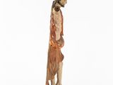 an old wooden statue of a man with long hair and a beard