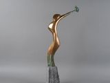 a bronze sculpture of a woman holding a flower in her hand