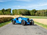 a blue car that is driving down the road
