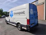 a blue and white van parked in a parking lot