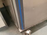 a silver refrigerator with a blue stripe on the door