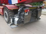 a large red and white truck with a crane on it ' s back