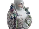 a figurine of a smiling buddha holding a baby