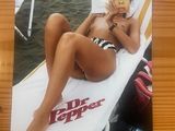 a picture of a woman in a bikini laying on a beach chair