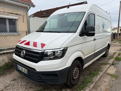 the white van is parked on the side of the road in front of a house