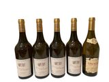 six bottles of wine sitting next to each other on a white surface