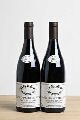 two bottles of wine sitting on top of a wooden table next to each other