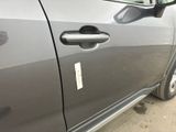 a close up of a car door handle with a sticker on it