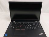 the laptop is open on a white surface with a black keyboard