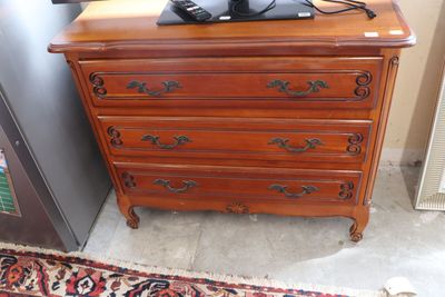 a wooden dresser with a television on top of it