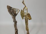 statue of a woman holding a fan and a man with a bird on his shoulder