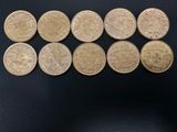 a close up of a bunch of coins sitting on top of a table
