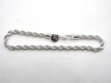 a close up of a silver chain with a heart on it