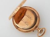 an antique pocket watch with a gold case and a gold chain