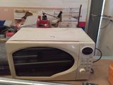 a microwave sitting on top of a table in a room