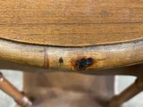 a close up of a wooden table with a black spot on it