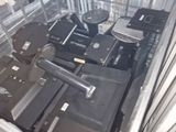 many suitcases sitting in a metal container on the floor