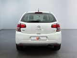 the rear end of a white citrole parked in a white room