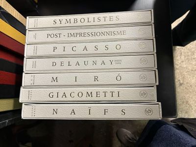 a stack of books sitting on top of a chair