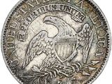 une pièce d'argent sur laquelle est représenté un aigle