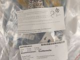 a stuffed animal in a plastic bag with a tag on it