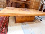 a wooden table with a drawer underneath it in a room