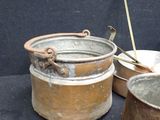 pots and pans are sitting on a black surface with a black background