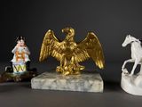 three figurines of a man riding a horse and a man riding a horse
