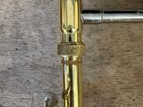 a close up of a brass pipe on a wooden floor