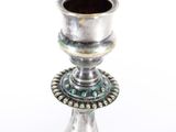a silver candle holder on a white background