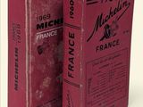 pair of red books sitting on top of each other in front of a white background