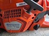 a chainsaw that is sitting on the ground next to a car