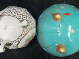 two teapots sitting next to each other on a table