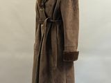 a brown coat with a fur collar on a mannequin stand