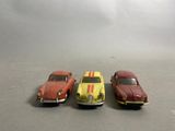 three toy cars that are sitting next to each other