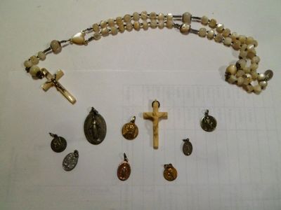 un chapelet, une croix et d'autres objets religieux disposés sur une table