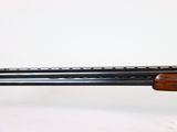 a close up of a rifle on a stand with a white background